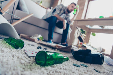 Concept of having headache after global party. Close up low-angle photo of empty green transparent...