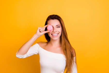 Hairstyle playful lovely happiness joke toothy naked shoulders brunette people person concept. Close up portrait of cute tender gentle beautiful lady closing eye with round cookies isolated backgroundの写真素材