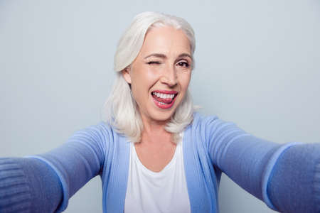 Close up portrait of happy cheerful delightful charming beautiful flirty mature lady granny grandma,...