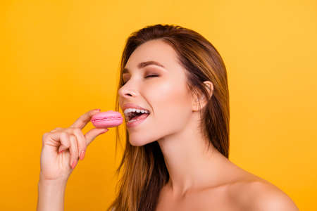 People closed eyes imagination people fantasy break-off sugary alluring concept. Close up portrait of sexual beautiful attractive skinny lady wans to try pastry  hold in hand isolated on backgroundの写真素材
