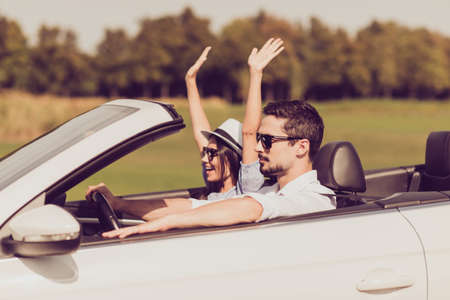 Destination relax, trip, park, auto vehicle rent, honeymoon relationship, friends, road escape, speed ride lifestyle. Beautiful lady wife express vitality, emotions, success, euphoria, fly, arms wingsの写真素材