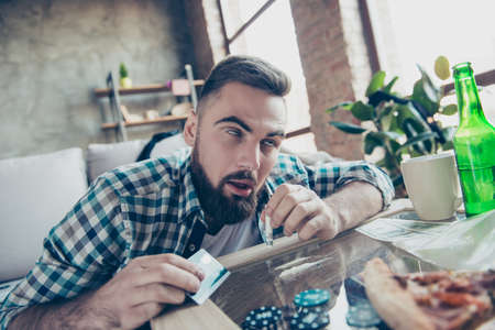 Close up portrait of crazy mad bearded hipster wearing checkered shirt he is feeling ecstasy because of taking drugsの写真素材