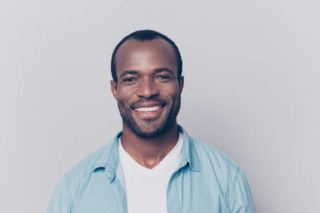 Portrait of virile, harsh, trendy, cheerful, glad man with beaming smile isolated on grey background