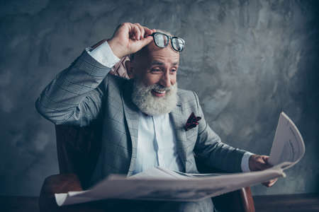 Attractive, laughing boss in suit take off glasses, look, watch, read conical facts, information in newspaper