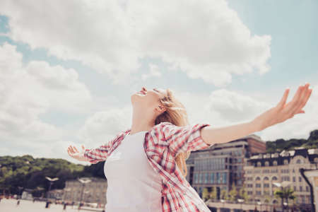 Low angle photo of carefree excited emotional lovely romantic cute gentle free beautiful attractive relaxed lady stretching armsの写真素材