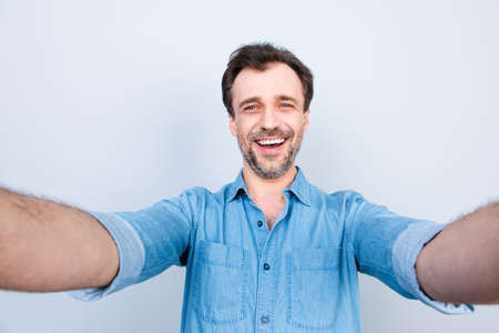 People person business refreshment success fortune concept. Close up portrait of cheerful excited amazed surprised, casual jeans denim clothes, taking self picture isolated on gray backgroundの写真素材