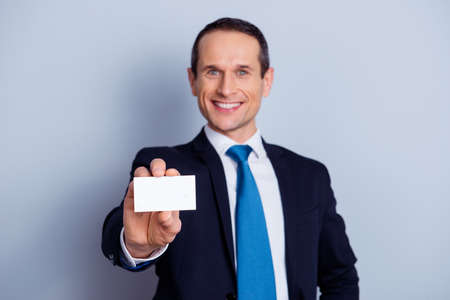 Close up portrait of friendly confident handsome leader boss chief manager demonstrating card with...