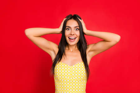 brunette girl touching head with two hands having open mouth, unexpected, unbelievable expression,...