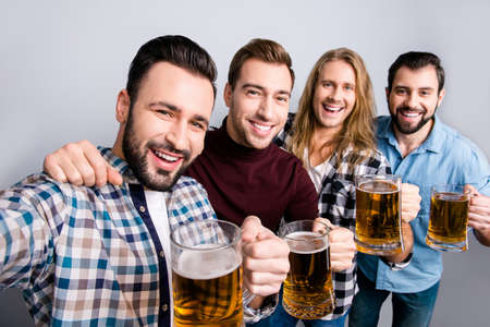 Success photographing football soccer holiday unity festive mood concept close up photo of handsome excited cheerful bearded toothy smiling guys making self picture hugging isolated on gray backgroundの写真素材