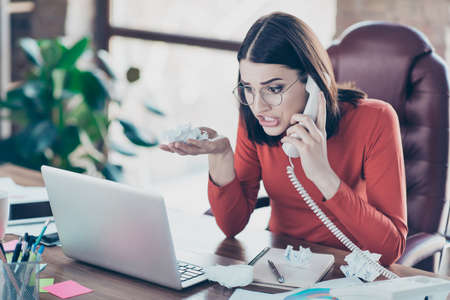 Indoors rage talk red sweater people employment corporate handset wild yell person grimacing...