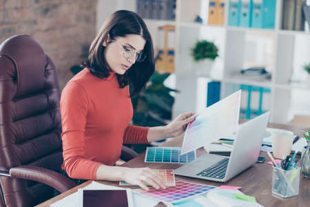 Renovation interior graphic student modern technology decorator makeover home paint picker decoration armchair decide eyewear glasses spectacles people person concept. Focused girl looks at gammaの写真素材