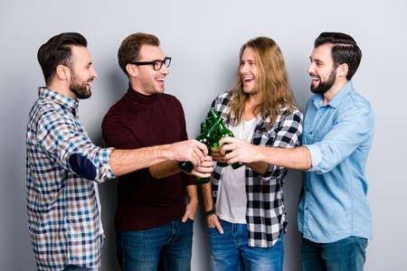 Ethnicity diversity recreation funtime virility masculinity concept. Excited cheerful joyful laughing handsoem guys ckinking bottles with alcohol beverage, checkered shirt isolated on gray backgroundの写真素材