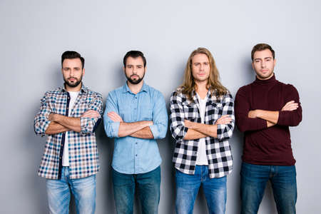 Harsh concentrated angry self-assured brutal macho strength success concept. Portrait of four calm peace man wearing checkered shirt turtleneck standing with crossed arms isolated on gray backgroundの写真素材
