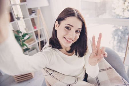 Self portrait of pretty, charming, nice, cute, stylish, brunette girl in pullover with modern...