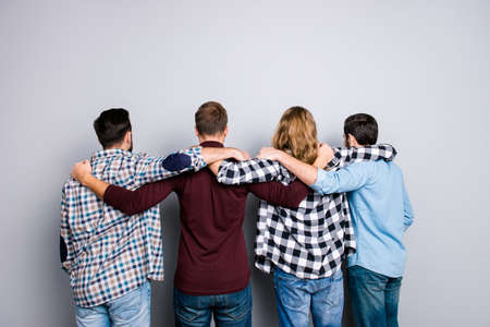 Leisure lifestyle leadership success virility masculinity brotherhood help concept. Handsome attractive different men, checkered denim clothes, putting arms on shoulders isolated on gray backgroundの写真素材