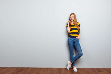 Full-length full-size portrait of confident pensive beautiful pretty cute careless  lovely sweet wearing casual outfit clothes touching hairdo looking aside isolated on ray background copyspaceの写真素材