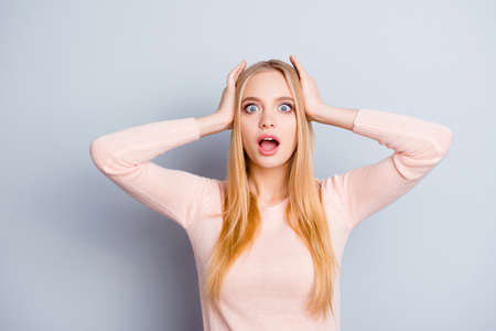 It's black friday! Unexpected incredible grimace people concept. Close up portrait of cute beautiful pretty lovely with big blue eyes businesswoman holding head with hands isolated on gray backgroundの写真素材