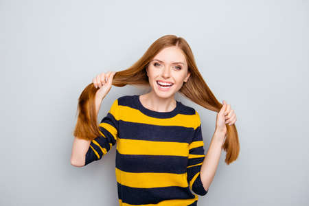 Fun stylish laughing yellow black redhead emotion expressing design stylist people funky fooling concept. Portrait of careless pretty with strong smooth straight hair girl isolated on gray backgroundの写真素材