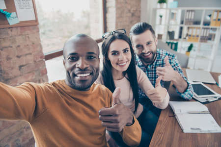 Agree advertising black afro desktop ethnicity leadership satisfaction company face concept. Close up portrait of excited cheerful friendly toothy beaming smile colleagues taking making selfieの写真素材