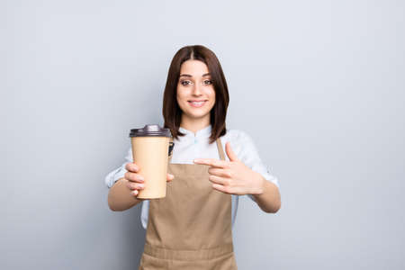 Sell snack order blank empty place for text sale discount you look fresh forefinger people person concept. Portrait of beautiful girl with bob hairdo holding big cup with cap isolated gray backgroundの写真素材