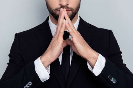 Cropped close up photo of serious strict severe calm mysterious angry aggressive financier economist making pyramid with hands thinking over new project isolated on gray backgroundの写真素材