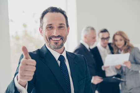 Portrait of attractive, stylish, confident, brunet director with stubble in tux with tie showing...