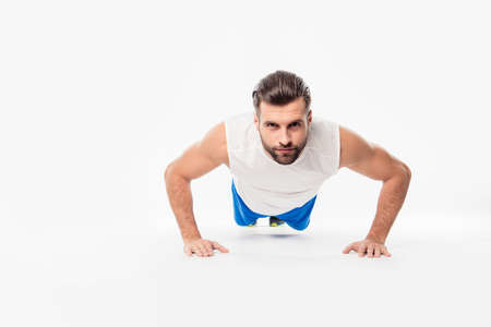 Front view  portrait of concentrated, confident, sporty, athletic, attractive  man making, showing...