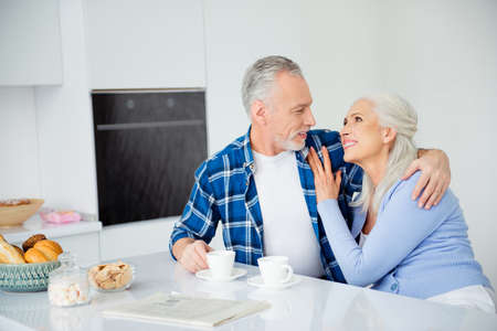 Portrait of lovely sweet stylish attractive couple sitting at table with cups of coffee bakery,...