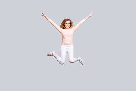 Full-length full-size portrait of cheerful delightful lady jumping up isolated on gray background