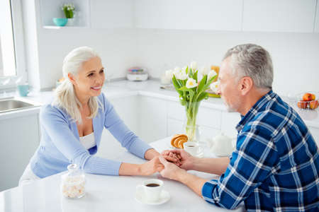 Portrait of lovely, sweet attractive stylish cheerful couple sitting at the table having brunch...