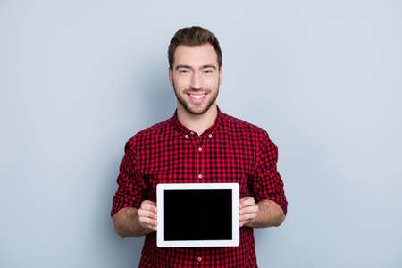 Portrait of cheerful glad confident excited professional guy showing ideal empty screen of updated...