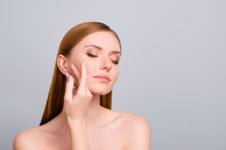 Procedure hydration aromatic tenderness model concept. Close up portrait of sensual sensitive feminine girlish cute lovely girl checking skin after taking shower isolated on gray background copy-spaceの写真素材