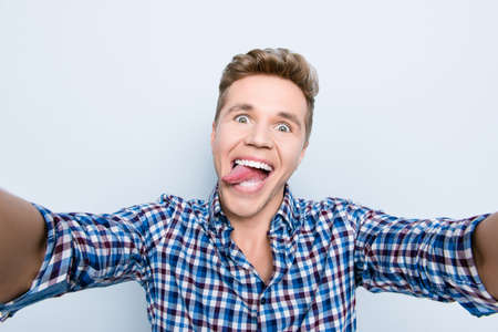 Close up portrait of crazy mad with big pop eyes excited cheerful laughing humorous comical tourist...