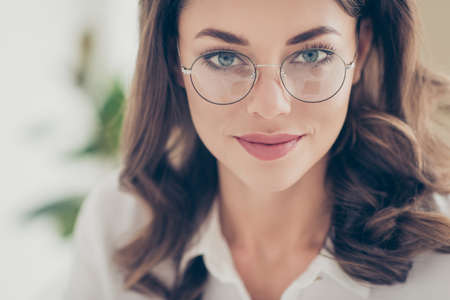 Cropped close up portrait of pretty, trendy, nice, cute, joyful, cheerful, positive, executive, corporate woman in glasses with natural make up looking at camera having perfect eyes plump lipsの写真素材
