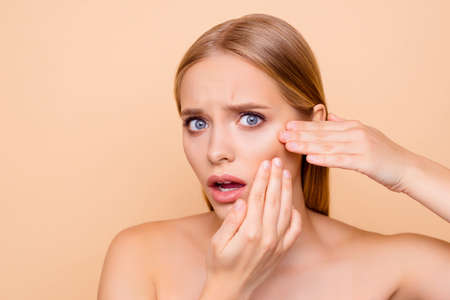 Sad, upset, frustrated, disappointed, nude, natural girl touching cheek with fingers having dry...