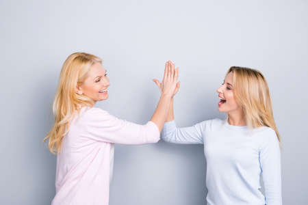 Give me high five, mother and daughter celebrating victory win, holding palms together clapping...
