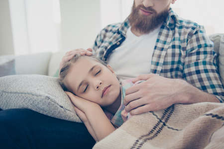 Cropped portrait of cute sweet sleeping princess calm schoolgirl with close eyes lying on father's...