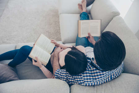 Top view portrait of well-read lettered couple enjoying reading novel poem, poetry fans, lying on...