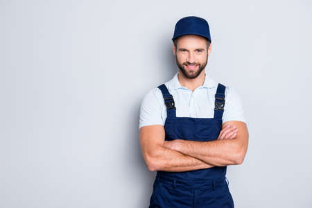Portrait with copyspace, empty place for advertisement of cheerful positive deliver in blue uniform...