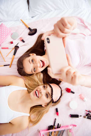 Portrait of joyful, cheerful, laughing, pretty, charming, stylish, successful girls in pink, white...