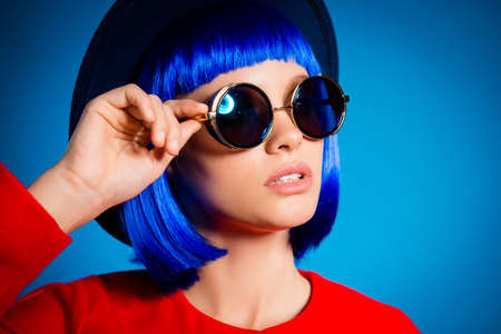 Closeup cropped portrait of pretty elegant girl in summer eyeglasses holding eyelet with hand...