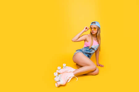 Portrait with copyspace empty place of naughty sensual girl holding eyelet of glasses on face looking away having booty bum isolated on yellow background, workout fitness body care conceptの写真素材