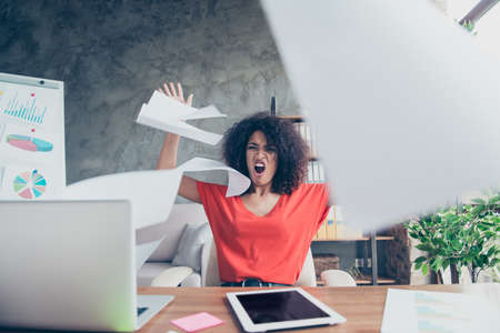 Portrait of angry violent financier in casual outfit throwing away documents yelling cruelly tired from routine sitting at desk. Education study university conceptの写真素材