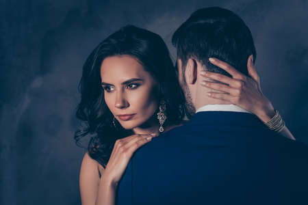 Portrait of pretty charming lady with earring bonding touching secret mysterious gentlemen with rear view, lovely mr and mrs isolated on grey backgroundの写真素材