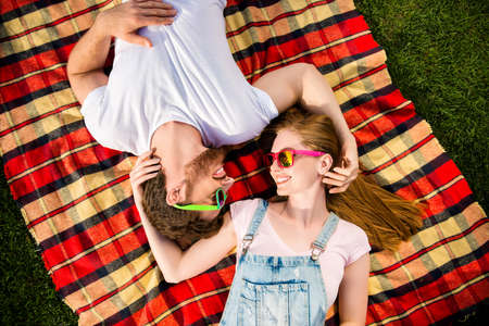 Trust support true feelings concept! Top view portrait of lovely sweet couple lying on checkered...