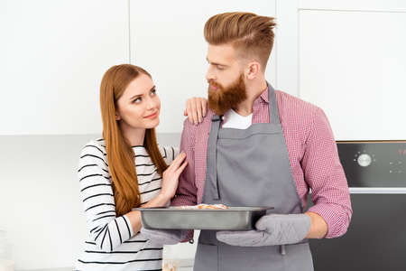 Affection flirt domestic casual feelings care concept Portrait of romantic lovely partners looking at each other, handsome man prepare sweet tasty pie for beautiful loverの写真素材