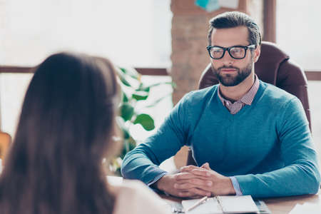 Job interview - Serious successful businessman listen carefully to candidate answers, sitting at...