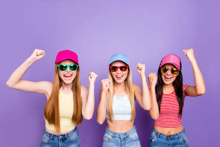 Portrait of glad cheerful triumphants holding hands up celebrating victory yelling isolated on...