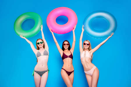 River sea water sunbathing suntan tan concept. Low angle view portrait of cheerful cool girls with...