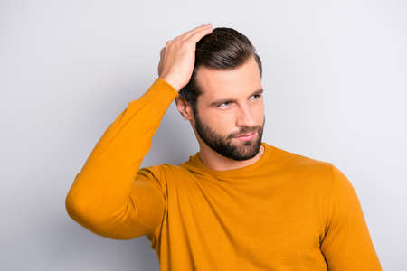 Close up portrait of attractive handsome virile masculine brutal guy combing back his long...